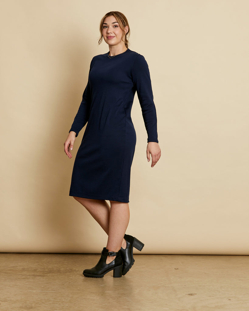 Woman wearing soft Australian Merino wool relaxed fitting long sleeve crew neck dress in navy. Designed as a relaxed fit and sitting around knee length. This style is perfect as a base to add other layers. Made in Australia at Woolerina's workrooms at Forbes in central west NSW.