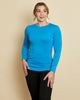 Woman wearing soft Australian Merino wool long sleeve crew neck in turquoise. Designed to wear next to the skin either as a base layer or as a t.shirt style on its own. This style is perfect for layering. Made in Australia at Woolerina's workrooms at Forbes in central west NSW.