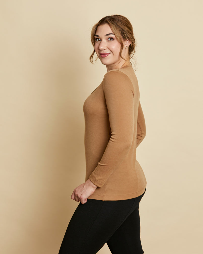 Woman wearing soft Australian Merino wool long sleeve scoop neck in camel. Designed to wear next to the skin as a base layer or on its own as a t.shirt style, it is perfect for layering! Made in Australia at Woolerina workrooms at Forbes in central west NSW.