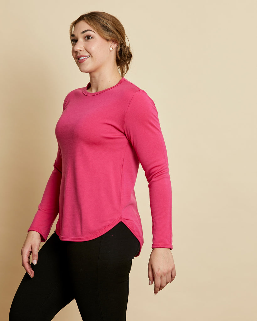 Woman wearing soft Australian Merino wool crew neck pullover in hot pink. Relaxed fitting, designed to wear over other layers as an outer layer or on its own next to the skin. Made in Australia at Woolerina's workrooms at Forbes in central west NSW.