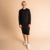 Woman wearing soft Australian Merino wool relaxed fitting long sleeve crew neck dress in black. Designed as a relaxed fit and sitting around knee length. This style is perfect as a base to add other layers. Made in Australia at Woolerina's workrooms at Forbes in central west NSW.